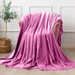 Oversized pink throw blanket draped over furniture