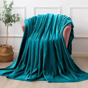 Oversized teal throw blanket draped over furniture