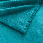 durable double-stitched edges and soft ring-spun fleece texture of a teal throw blanket