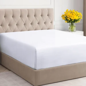 An extended twin bedsheet with perimeter elastic to maintain shape and tension through commercial laundry cycles