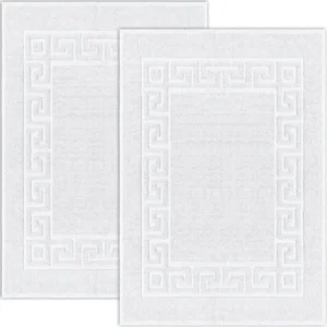 Luxury bath mats with an embossed Greek Key border design.