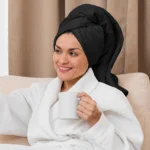 Guest using Black bath towels in a professional spa setting