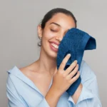 Guest drying her face with the soft face towel