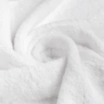 White 12"x12" washcloth swirled to show the absorbent cotton-blend loops and consistent pile texture