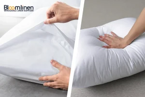 Hand pressing into a white hotel pillow to demonstrate loft retention and fiber resilience